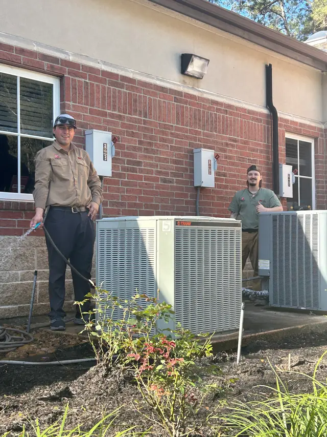 Two Jack Gordon and Sons technicians servicing outdoor condensers