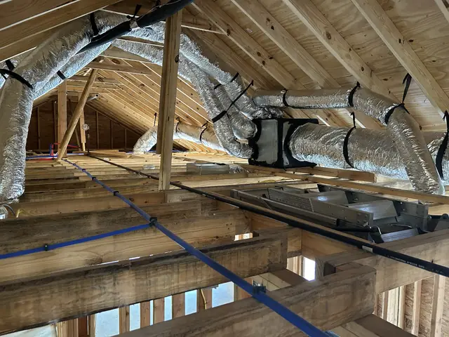 Insulated ductwork run through a new-construction attic